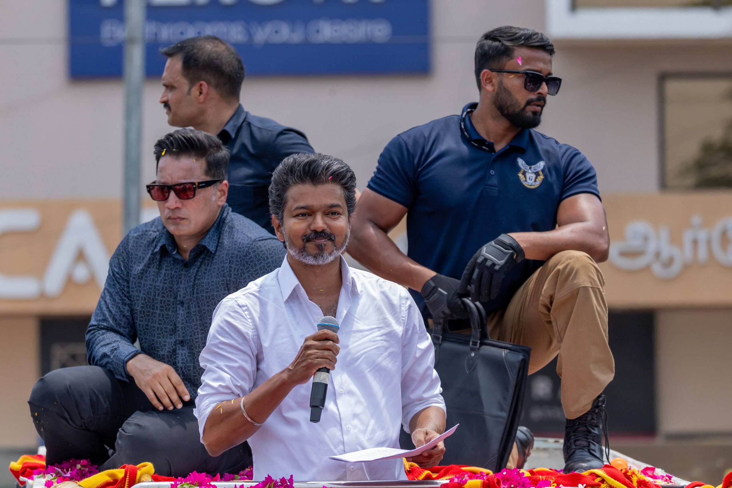 Vijay greeting supporters during a campaign event